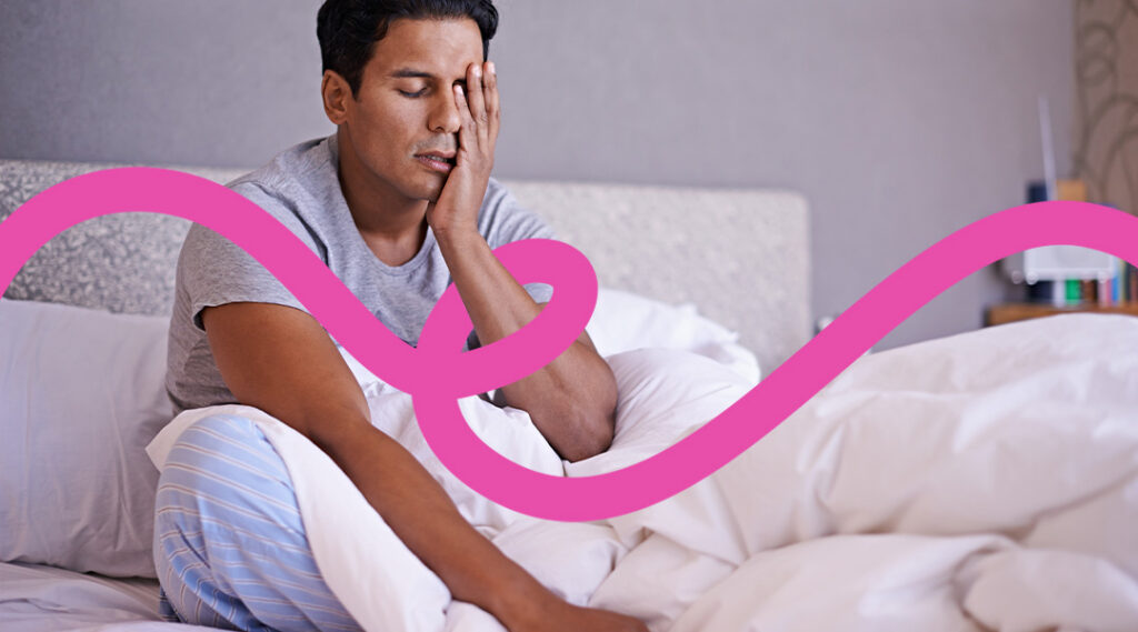 Man sitting up in bed with eyes closed, hand on his face, looking exhausted; a pink wavy overlay runs across the scene